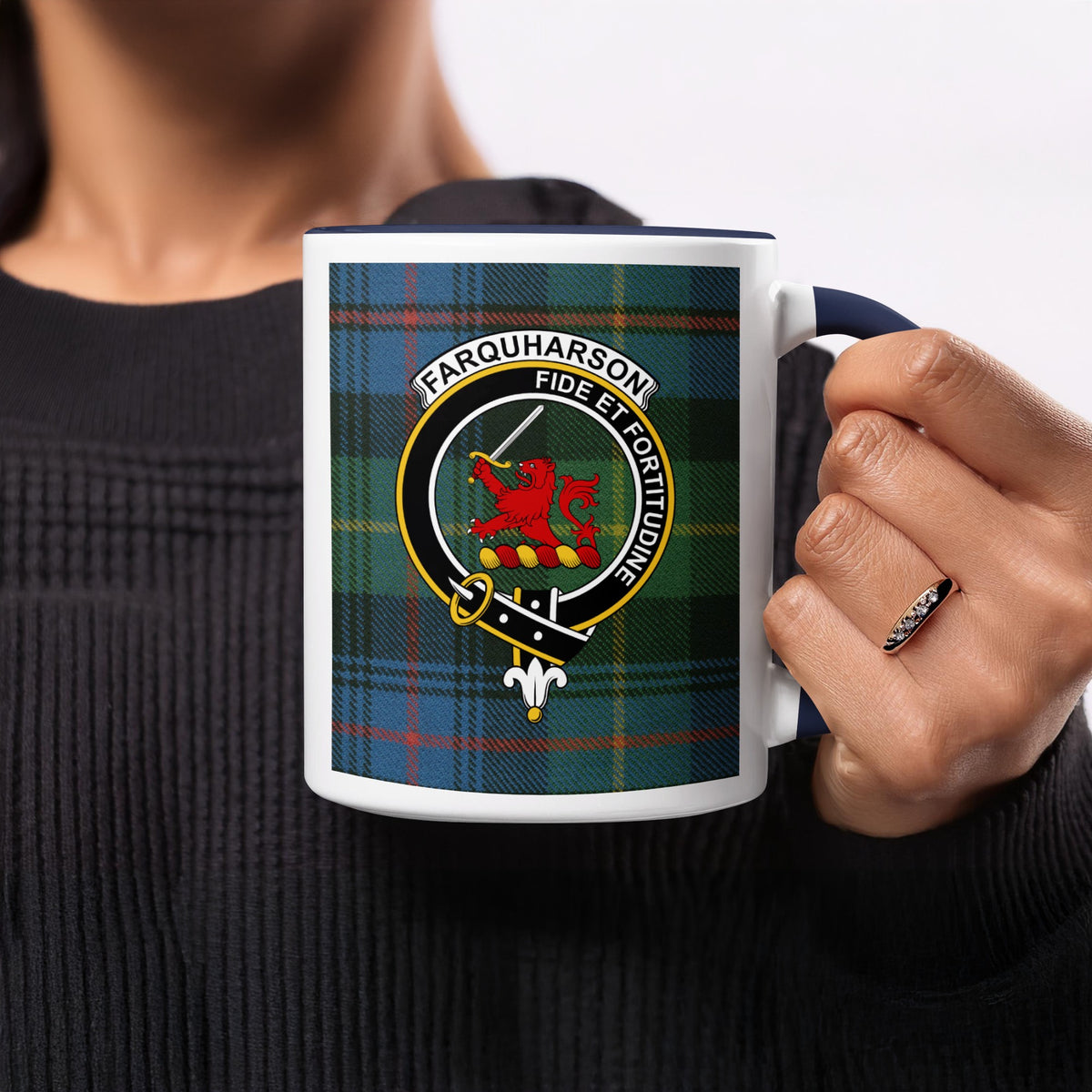 Close-up lifestyle view of Farquharson Scottish clan crest artwork on a navy 11 oz accent mug with a tartan background