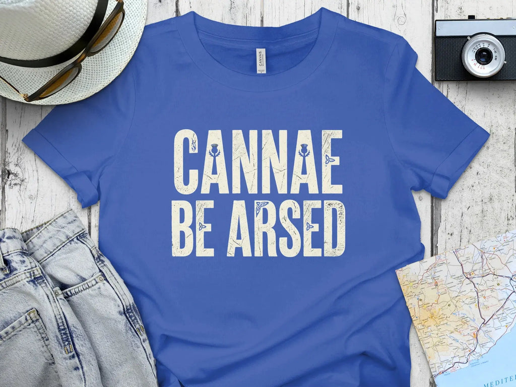 Blue t-shirt with white text "CANNAE BE ARSED" and thistle graphics.