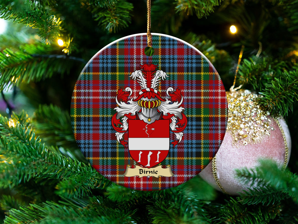 Birnie Scottish clan ceramic ornament with family crest on a Caledonia tartan background, hanging on a Christmas tree