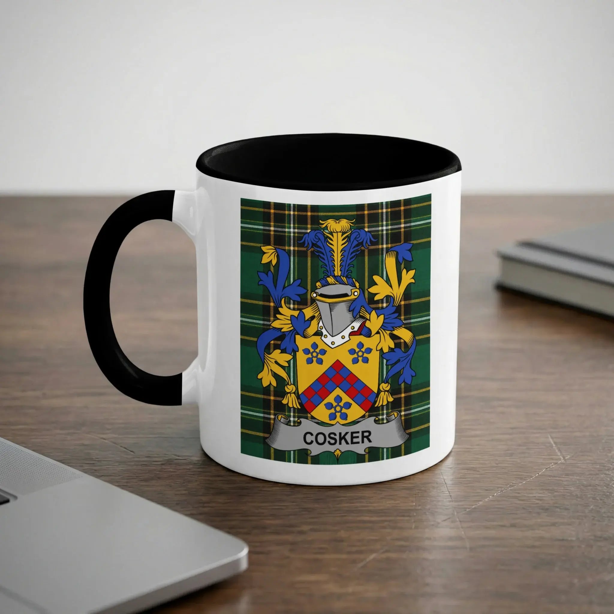 White mug with black rim and handle, featuring the Cosker family crest.