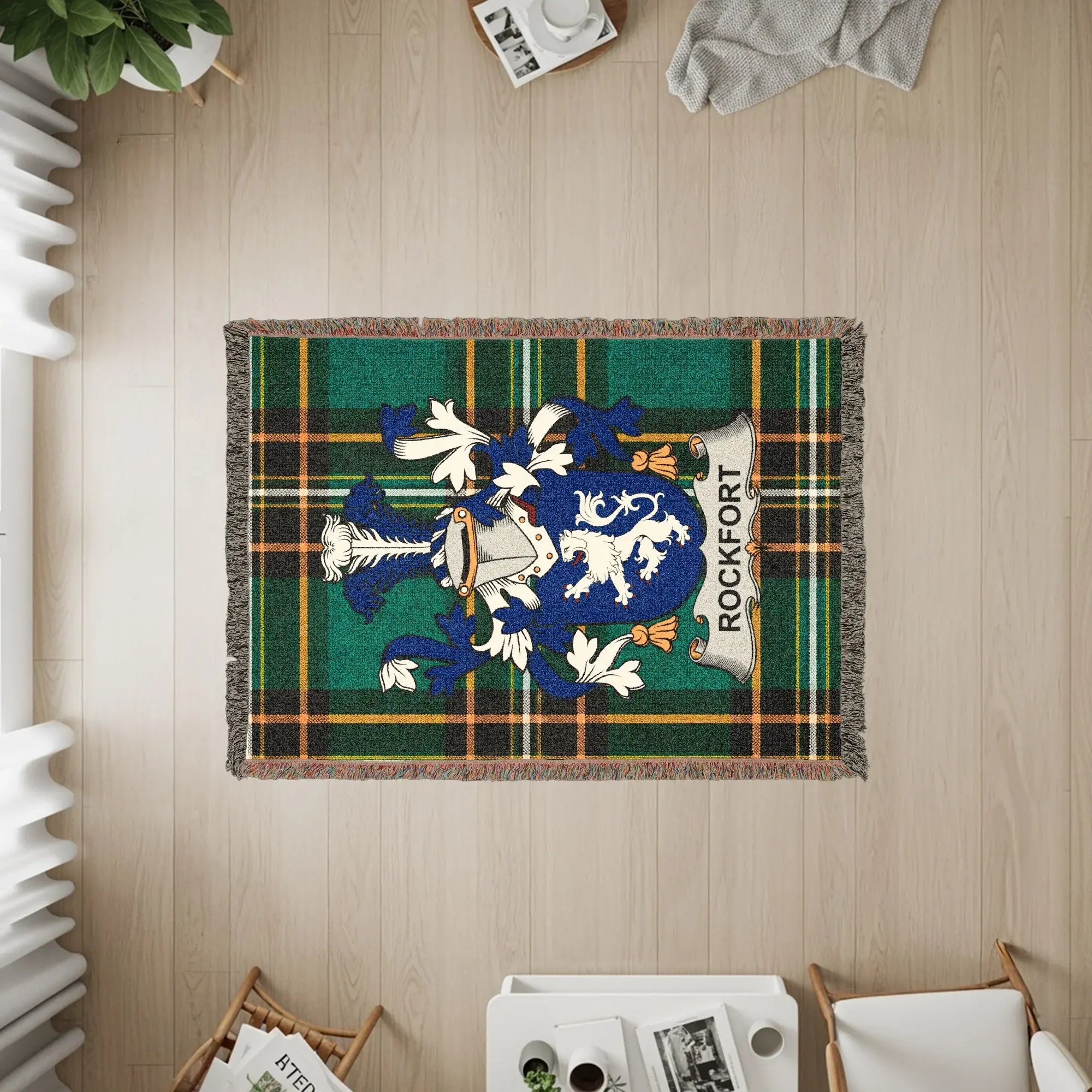 Woven blanket with Rockfort crest and plaid design.