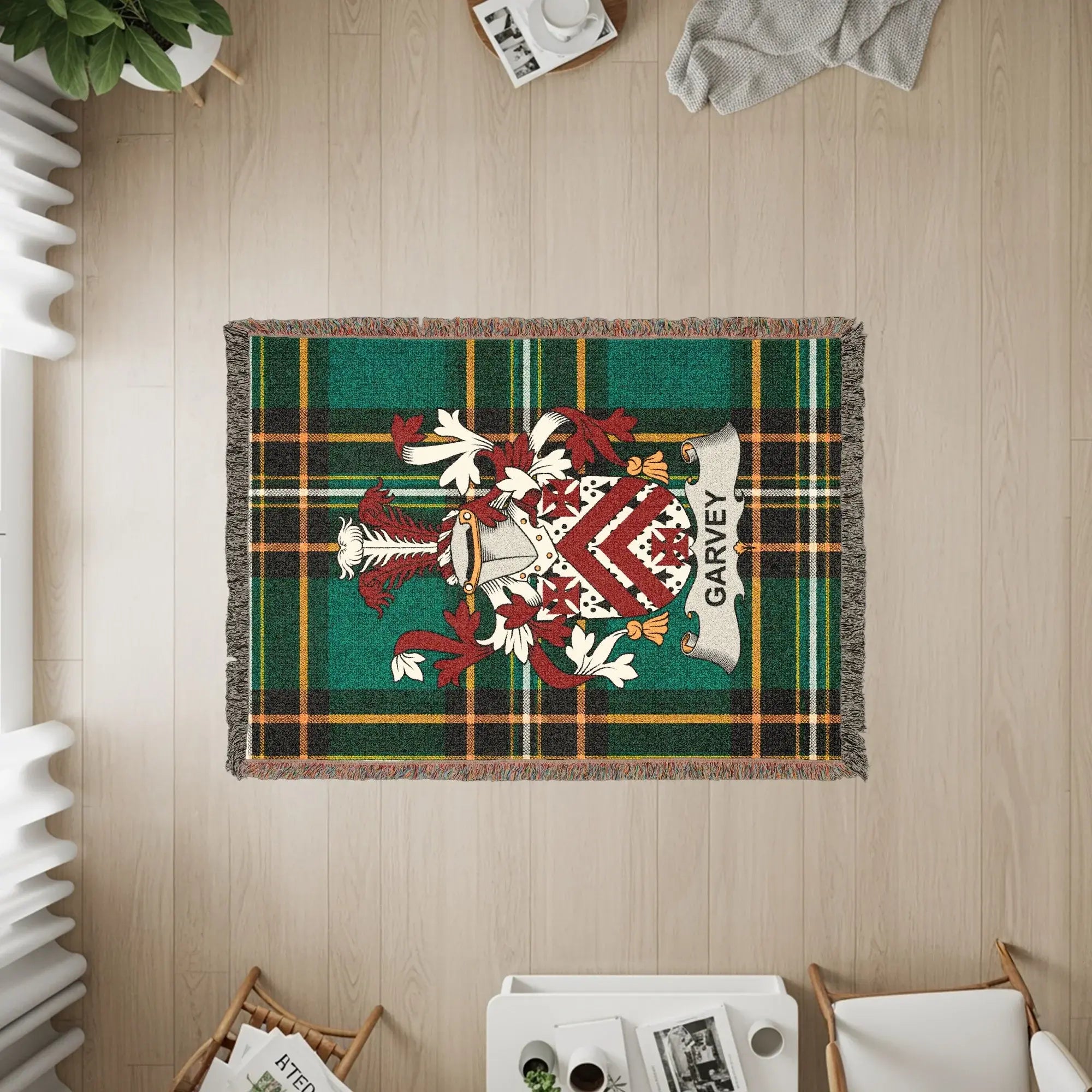 Green tartan throw blanket with a Garvey family crest.