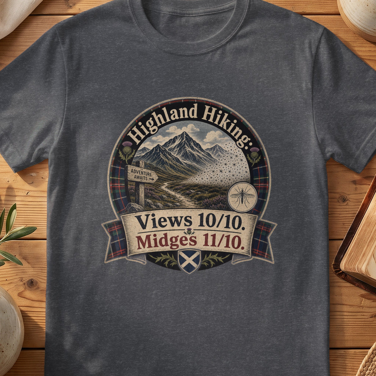Dark grey Gildan 64000 unisex T-shirt flatlay with Highland Hiking Midges Scottish graphic design