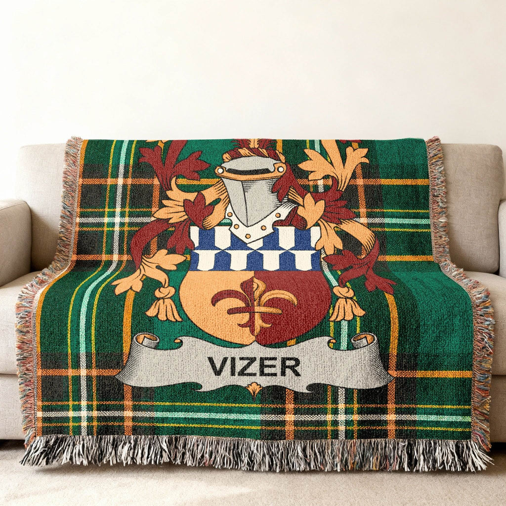 Green plaid throw blanket with Vizer family crest centered.