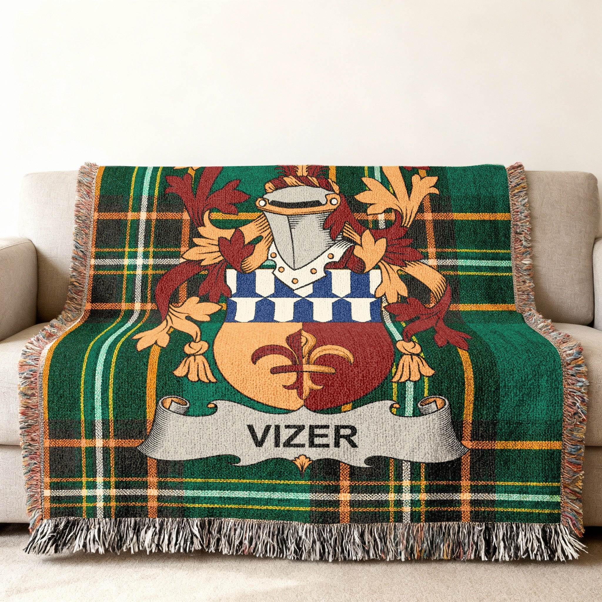 Green plaid throw blanket with Vizer family crest centered.