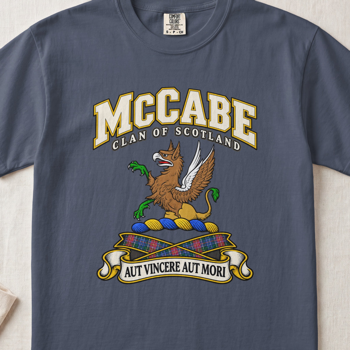 McCabe Scottish clan T-shirt in Midnight, front view with a brown and gold winged griffin with green claws and motto banner.