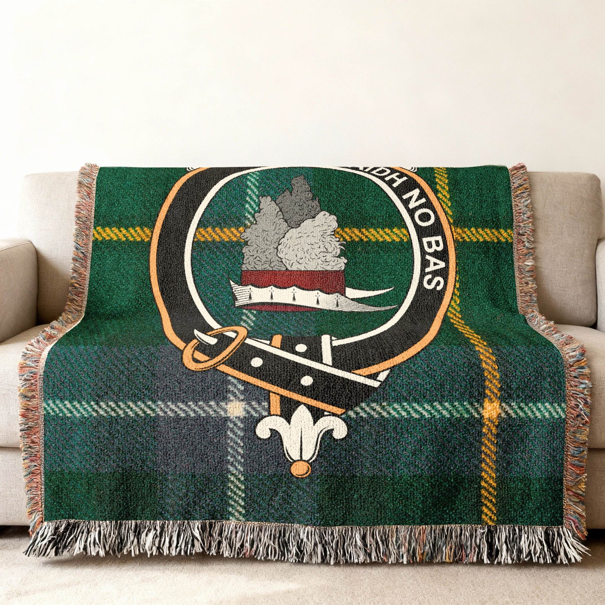 MacNeil clan crest tartan woven throw blanket draped over sofa — full pattern in clan colours