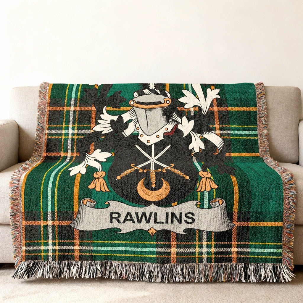 Green tartan blanket with the RAWLINS family crest draped on a sofa.