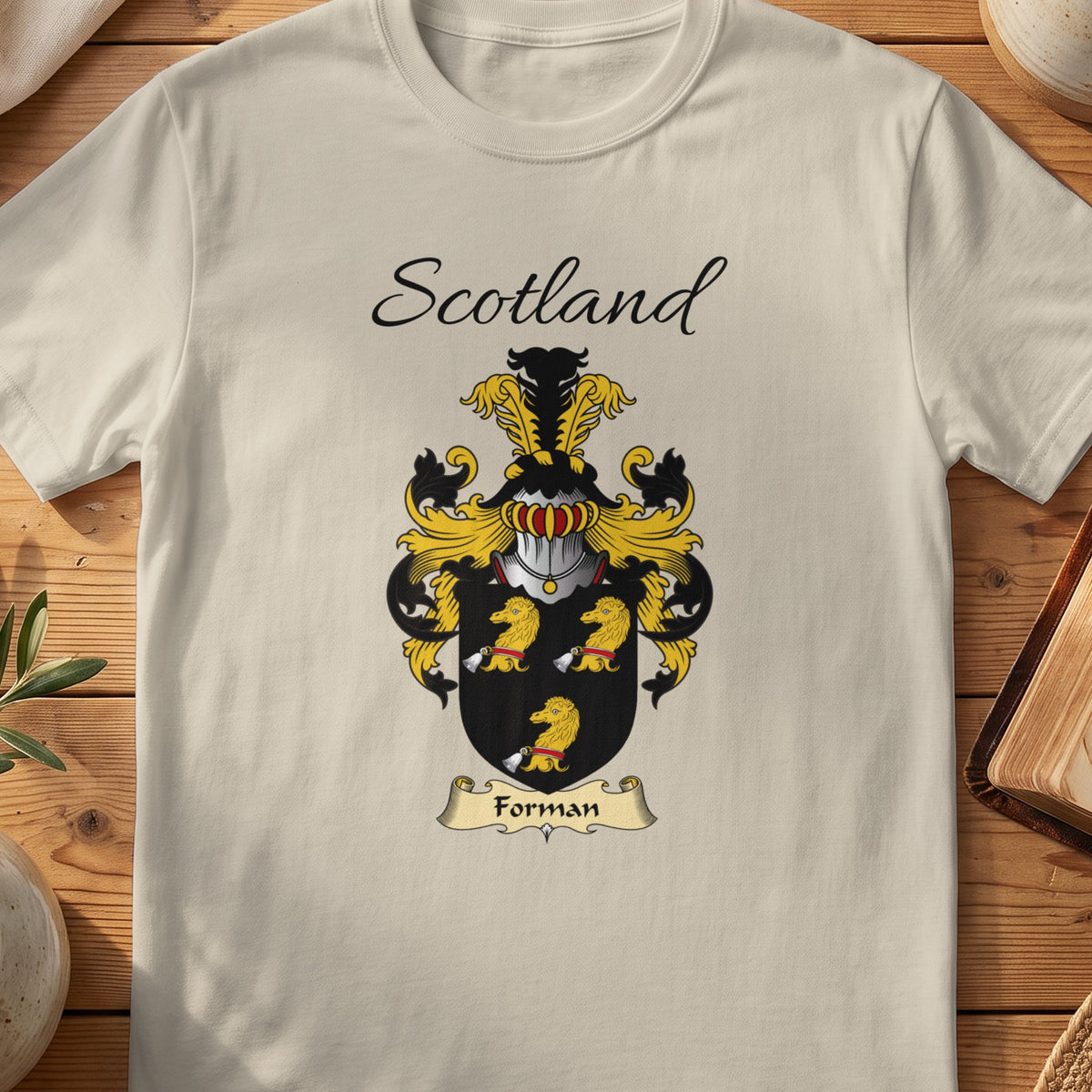 Sand Forman Scottish family shield T-shirt featuring three gold animal heads on black