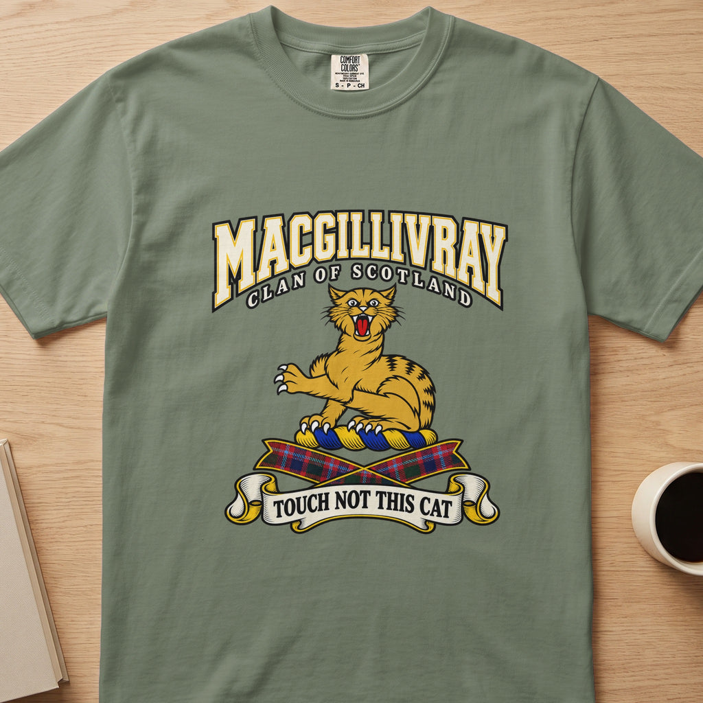 MacGillivray clan crest with gold striped cat on a sage green Comfort Colors T-shirt, front view