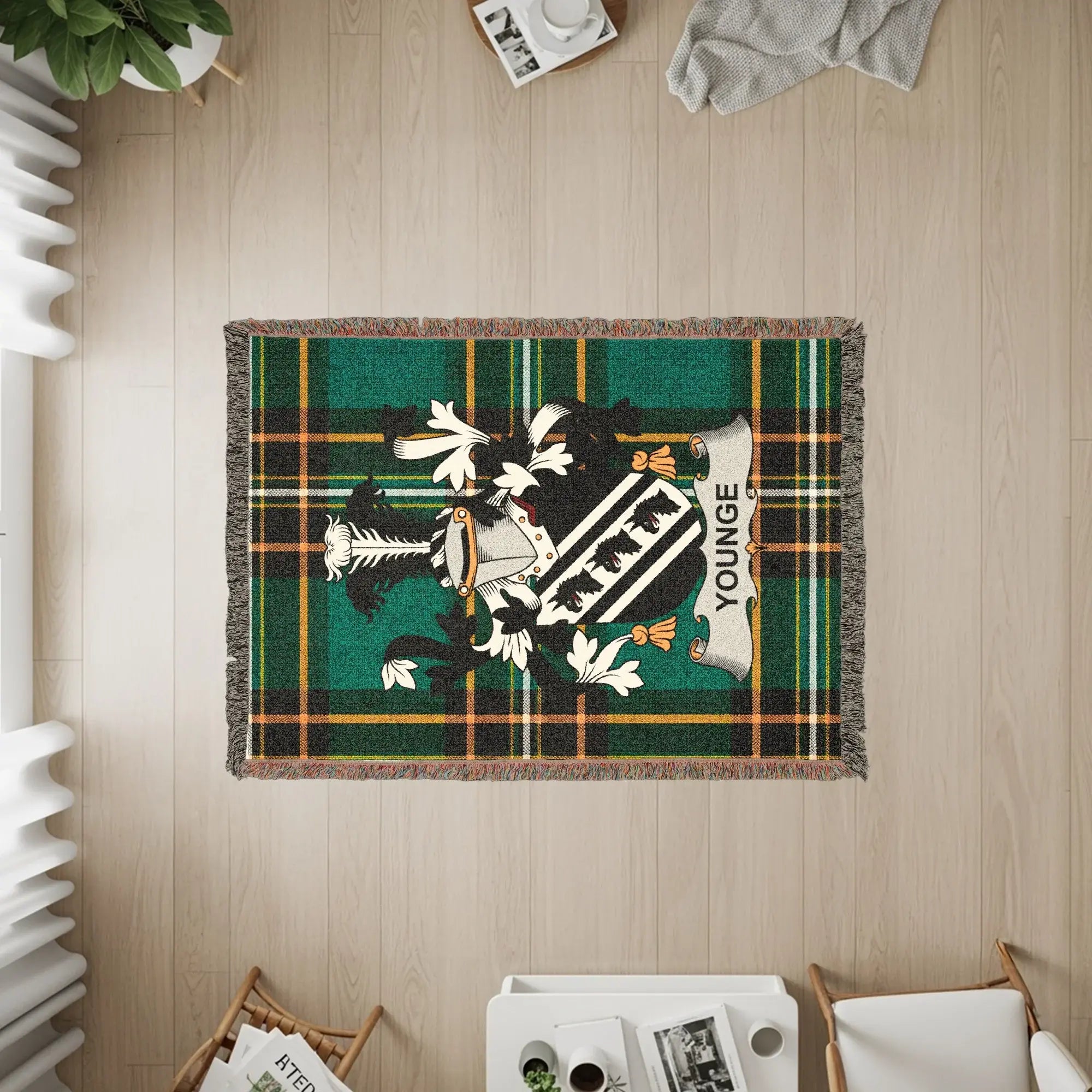 Green tartan blanket with the Youn ge coat of arms displayed.