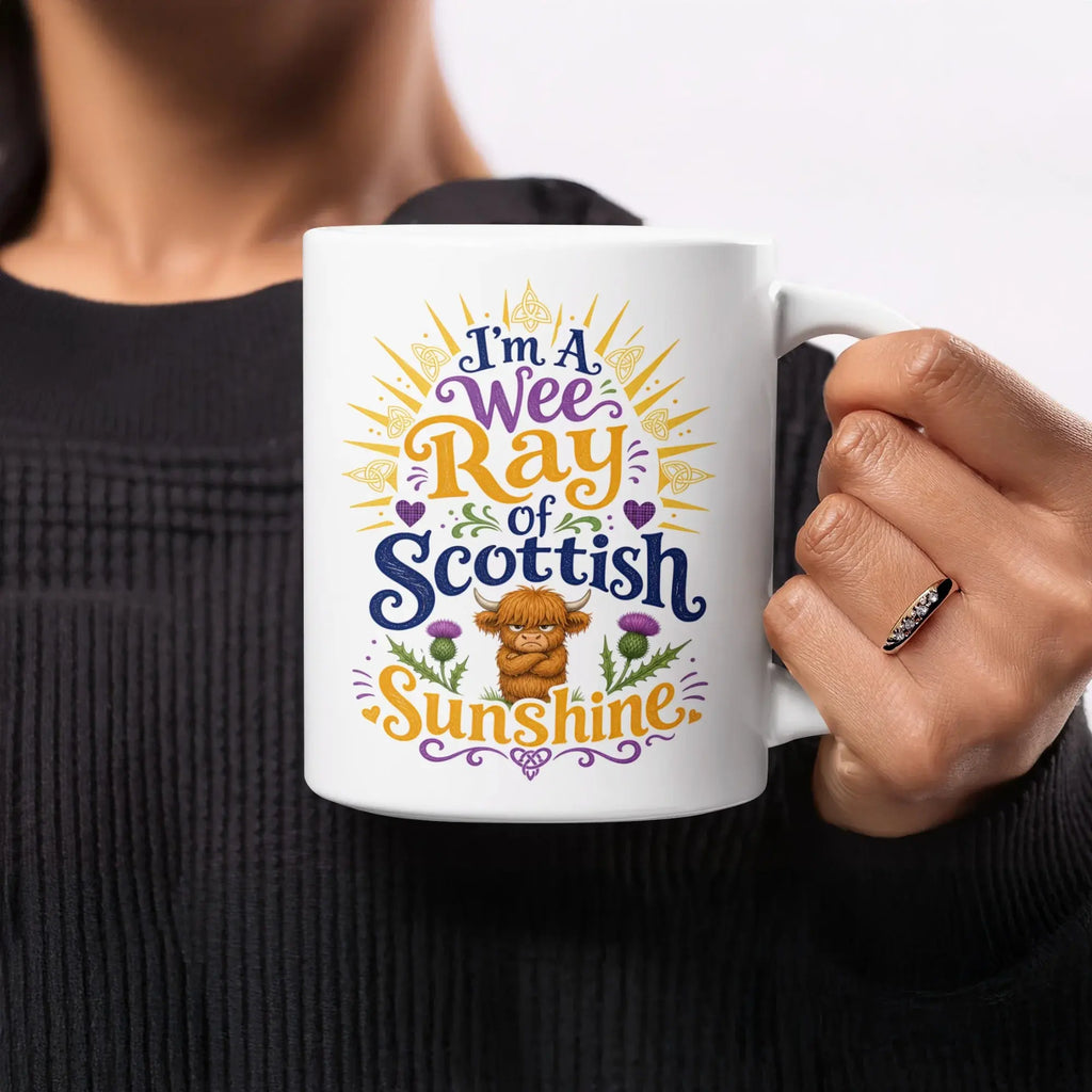 Mug with "I'm a Wee Ray of Scottish Sunshine" text and thistle graphic.