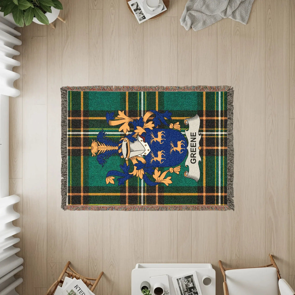 Green crest with plaid background on a woven tapestry throw blanket.