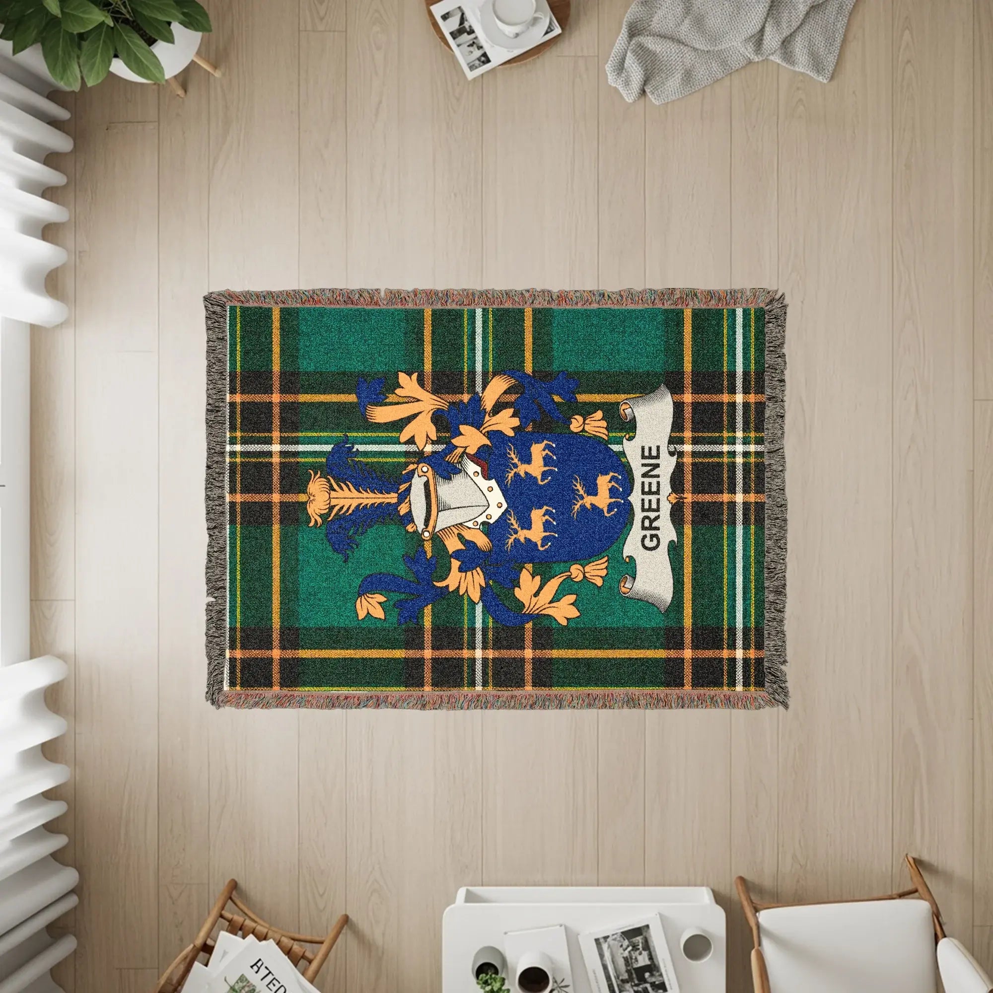 Green crest with plaid background on a woven tapestry throw blanket.