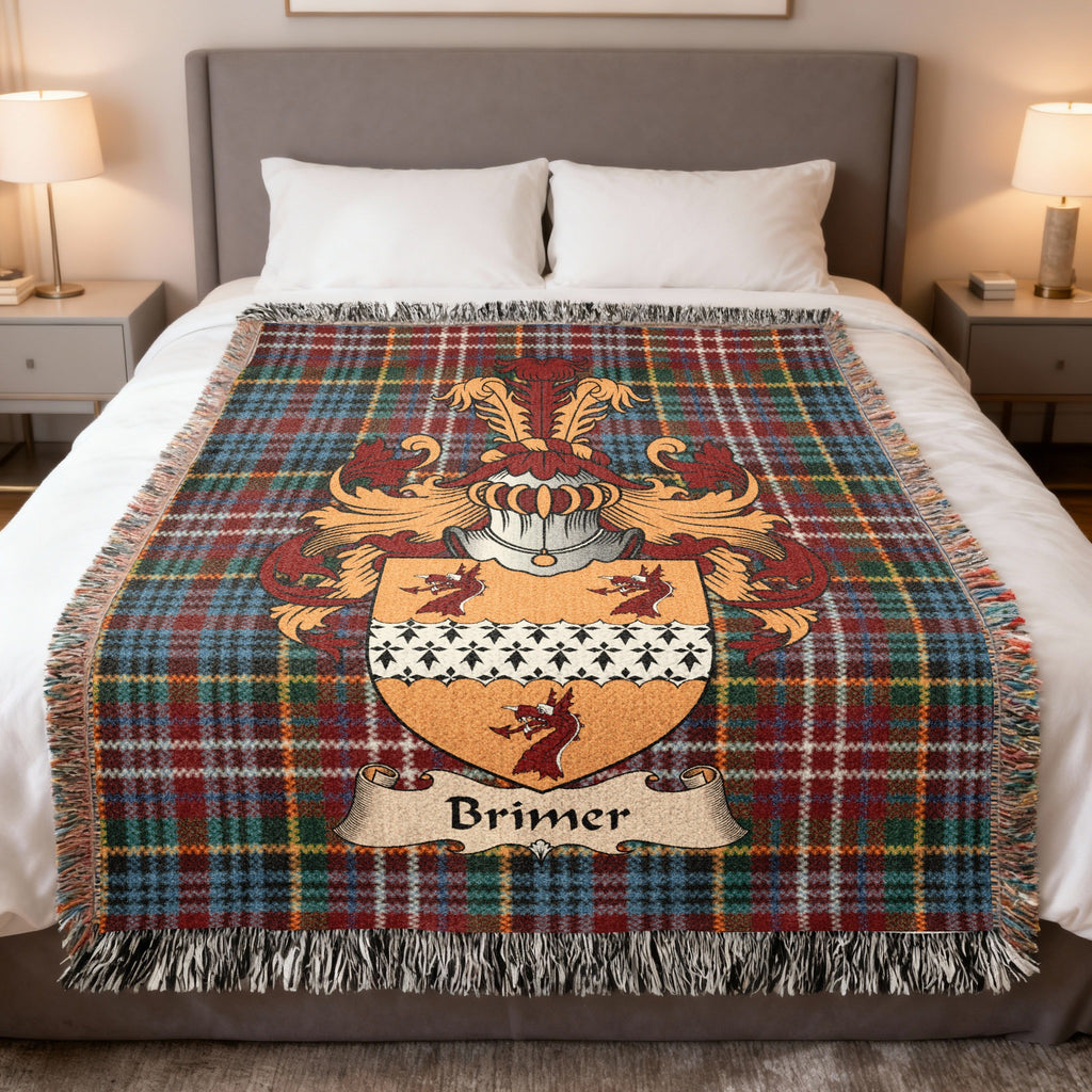 Brimer family crest emblem on a Caledonia tartan woven blanket