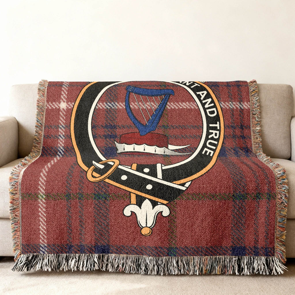 Rose tartan woven blanket folded — showing crest and red plaid design