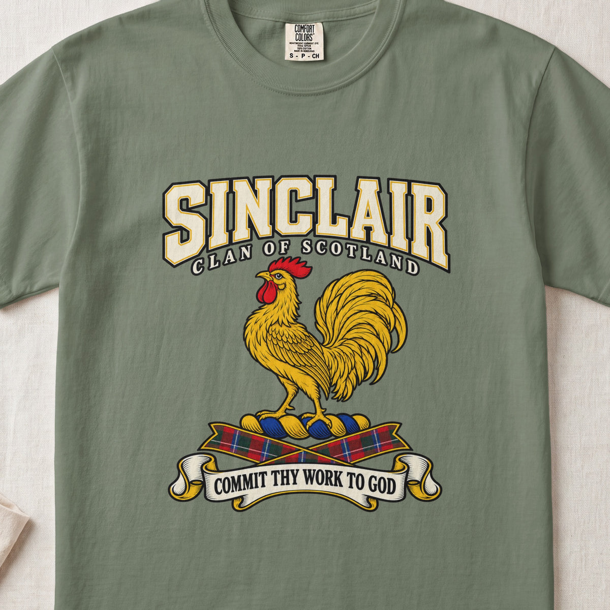 Sinclair graphic T-shirt in Moss green, front flat lay showing varsity lettering and gold rooster with red comb and wattle.
