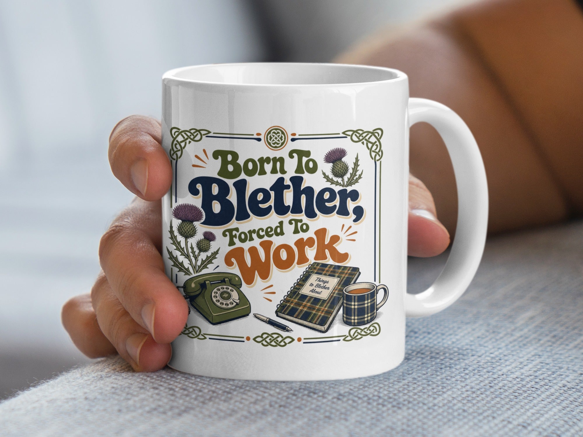 White mug with "Born to Blether, Forced to Work" text and Scottish thistle designs.