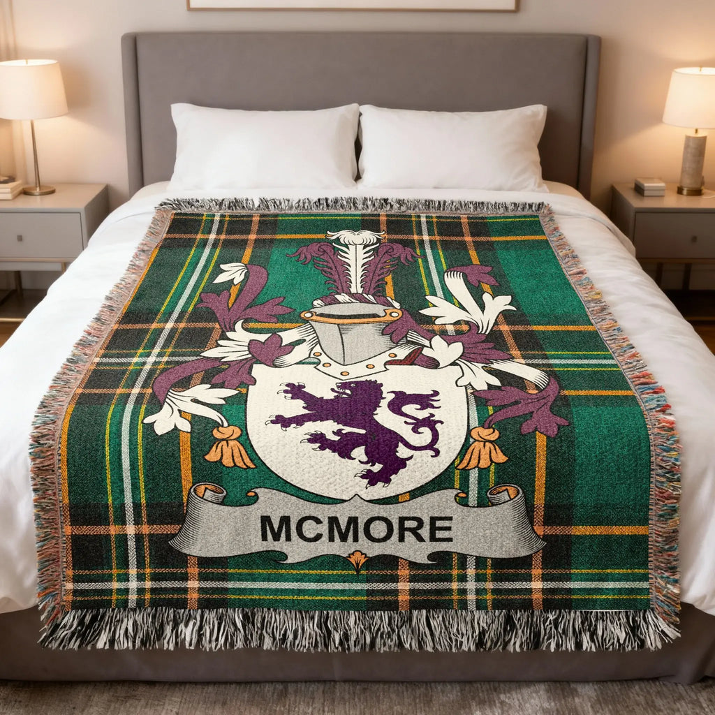 McMore family crest on green plaid woven blanket draped on a bed.
