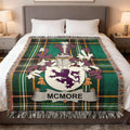McMore family crest on green plaid woven blanket draped on a bed.