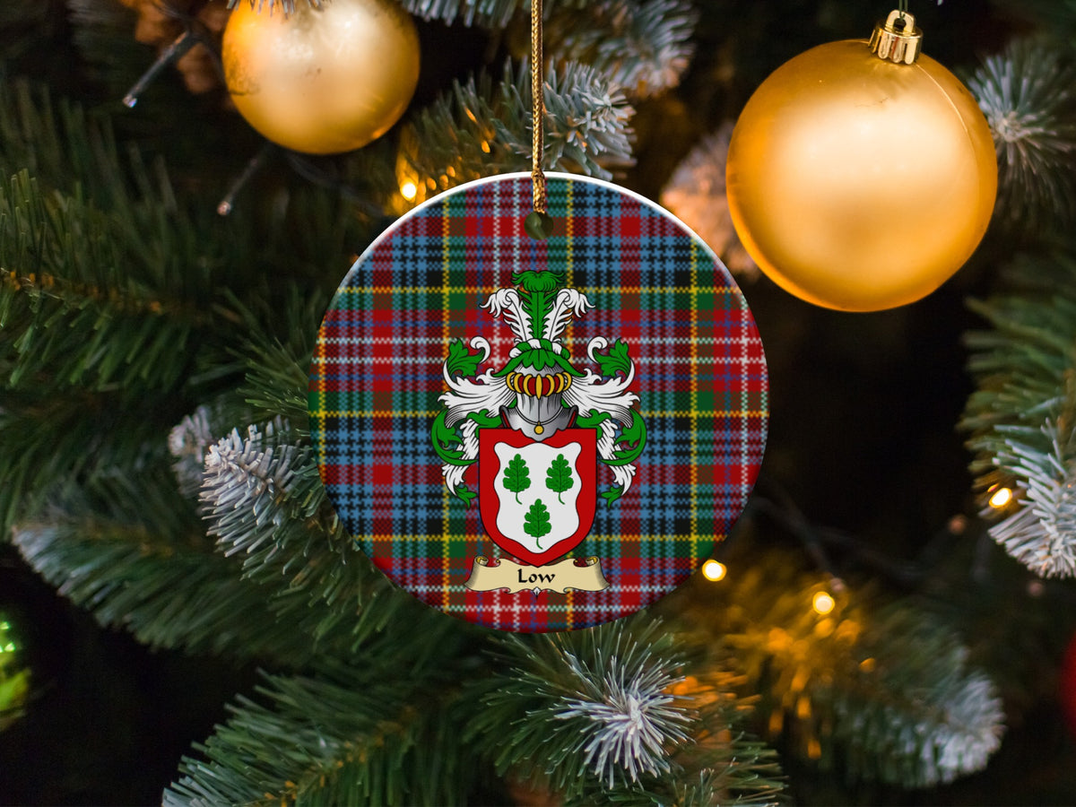 Low family emblem ceramic Christmas ornament with Caledonia tartan background in festive holiday décor