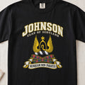 Johnson Scottish clan T-shirt in Black, front view with a golden winged emblem beneath a star and motto banner.