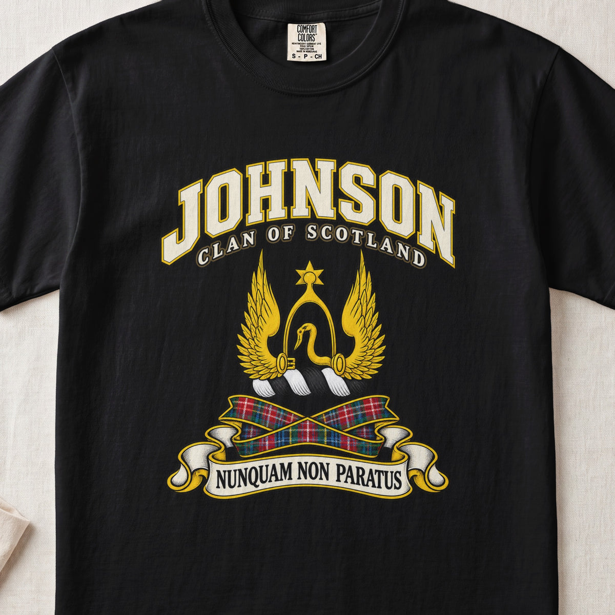 Johnson Scottish clan T-shirt in Black, front view with a golden winged emblem beneath a star and motto banner.
