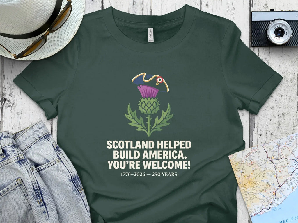 Dark green t-shirt with Scottish thistle and "Scotland Helped Build America" text.