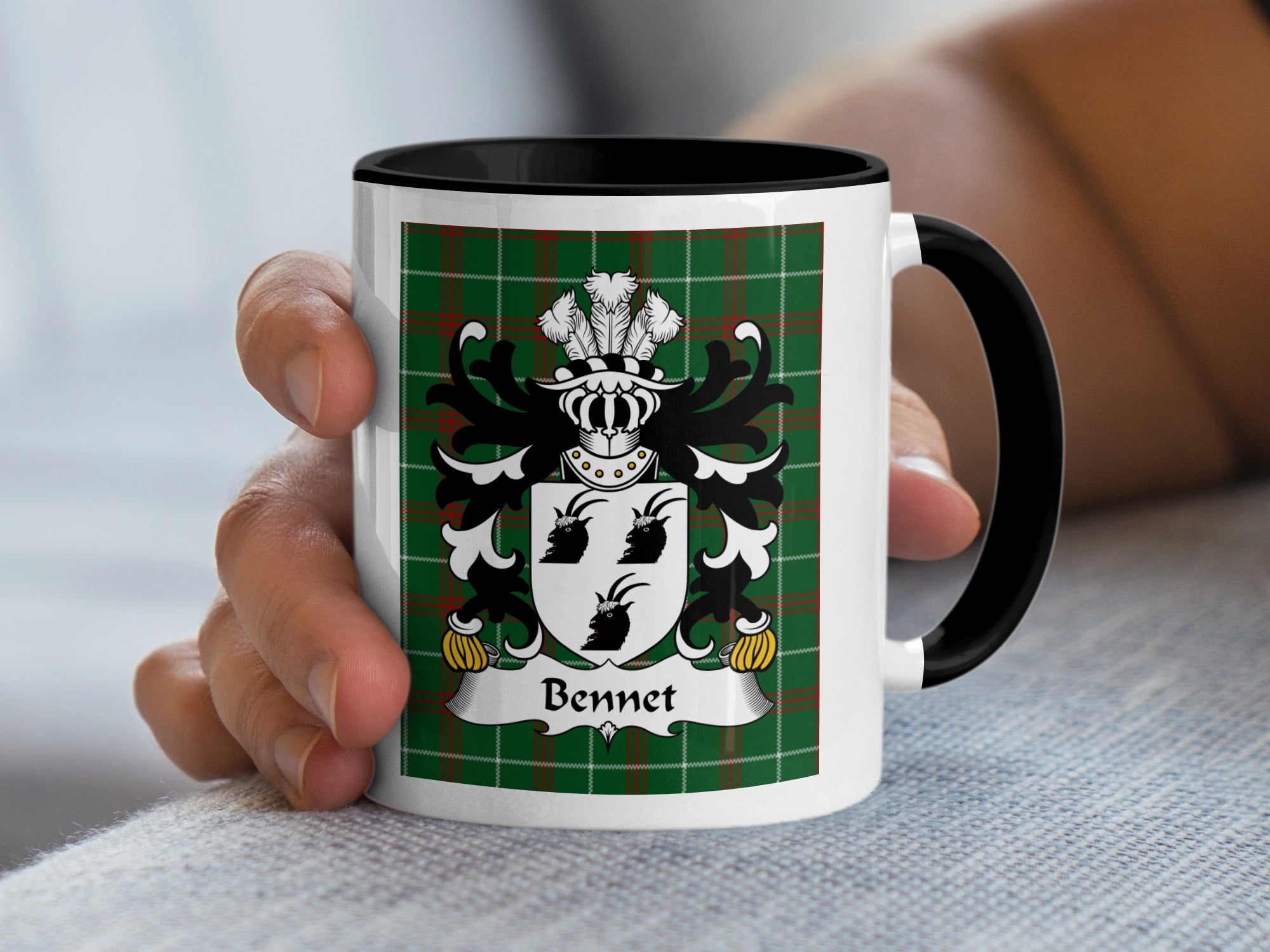 White mug with black handle featuring the Bennet family crest on a green tartan background.