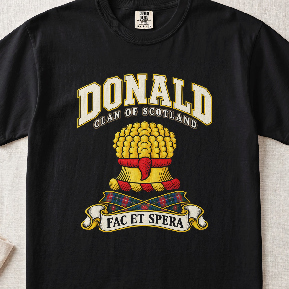 Donald Scottish clan T-shirt in Black, front view with a gold sheaf of wheat and motto banner.