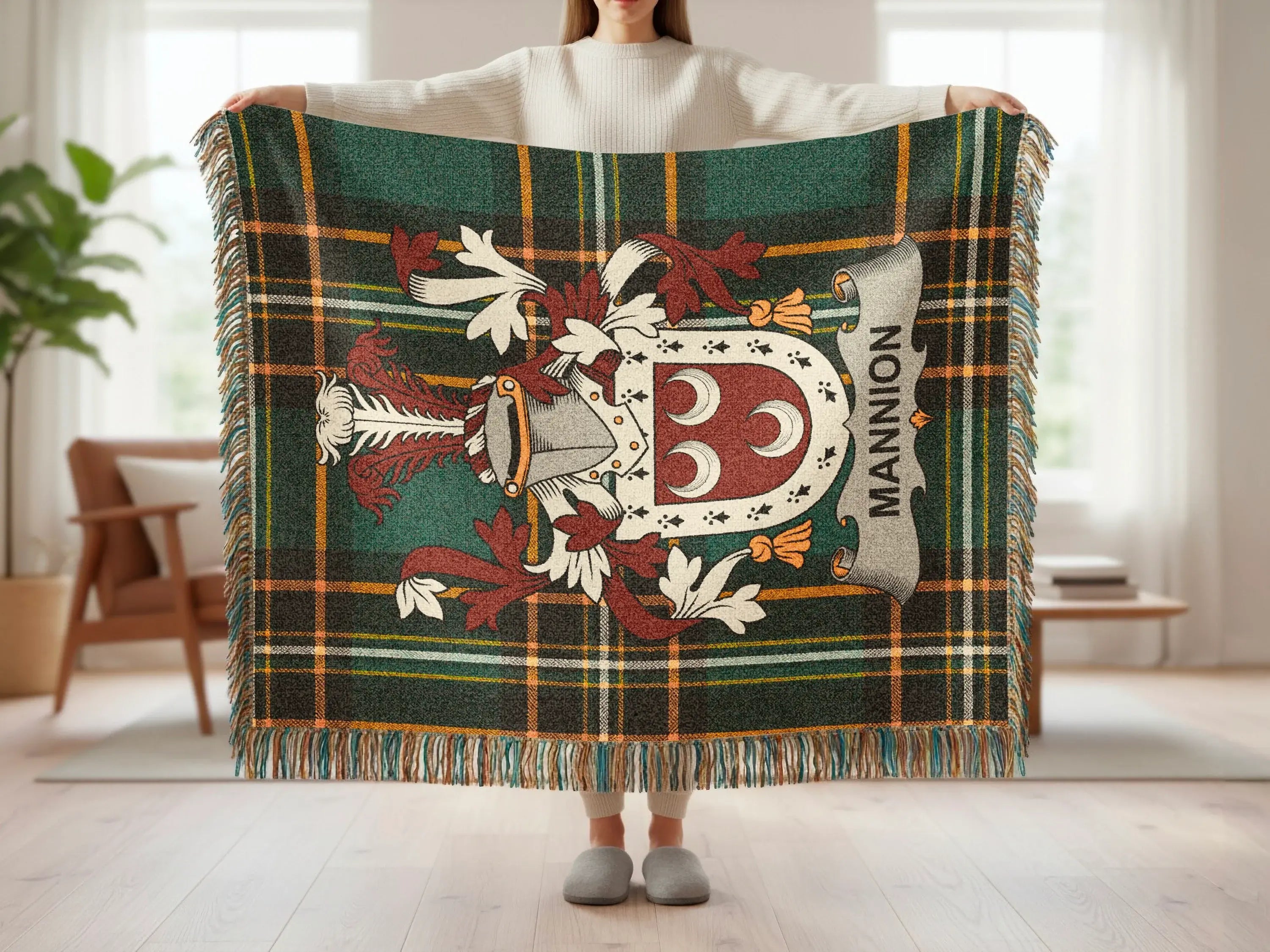 Tartan throw blanket with a crest and "MANNION" text.