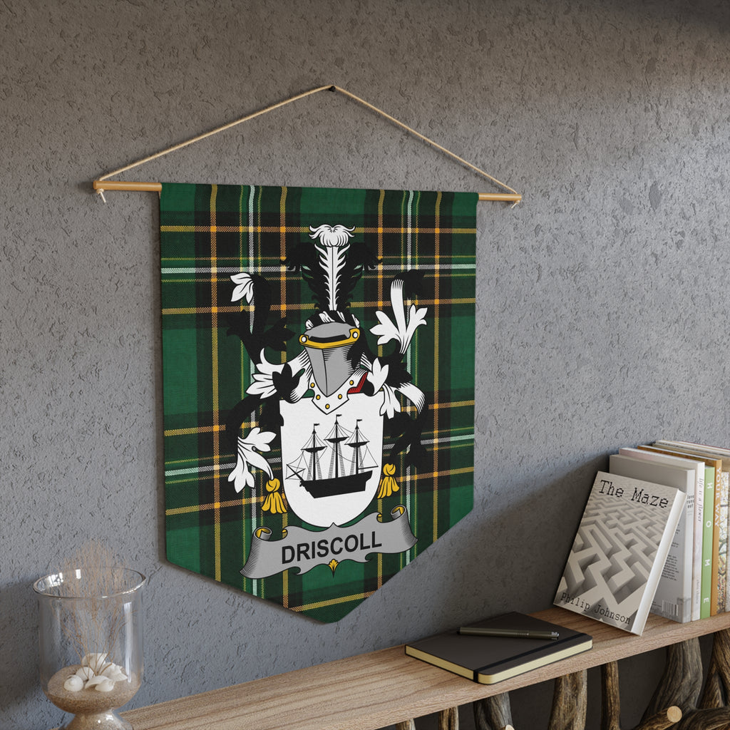 Driscoll family crest banner with tartan pattern and ship, hanging on a wall.