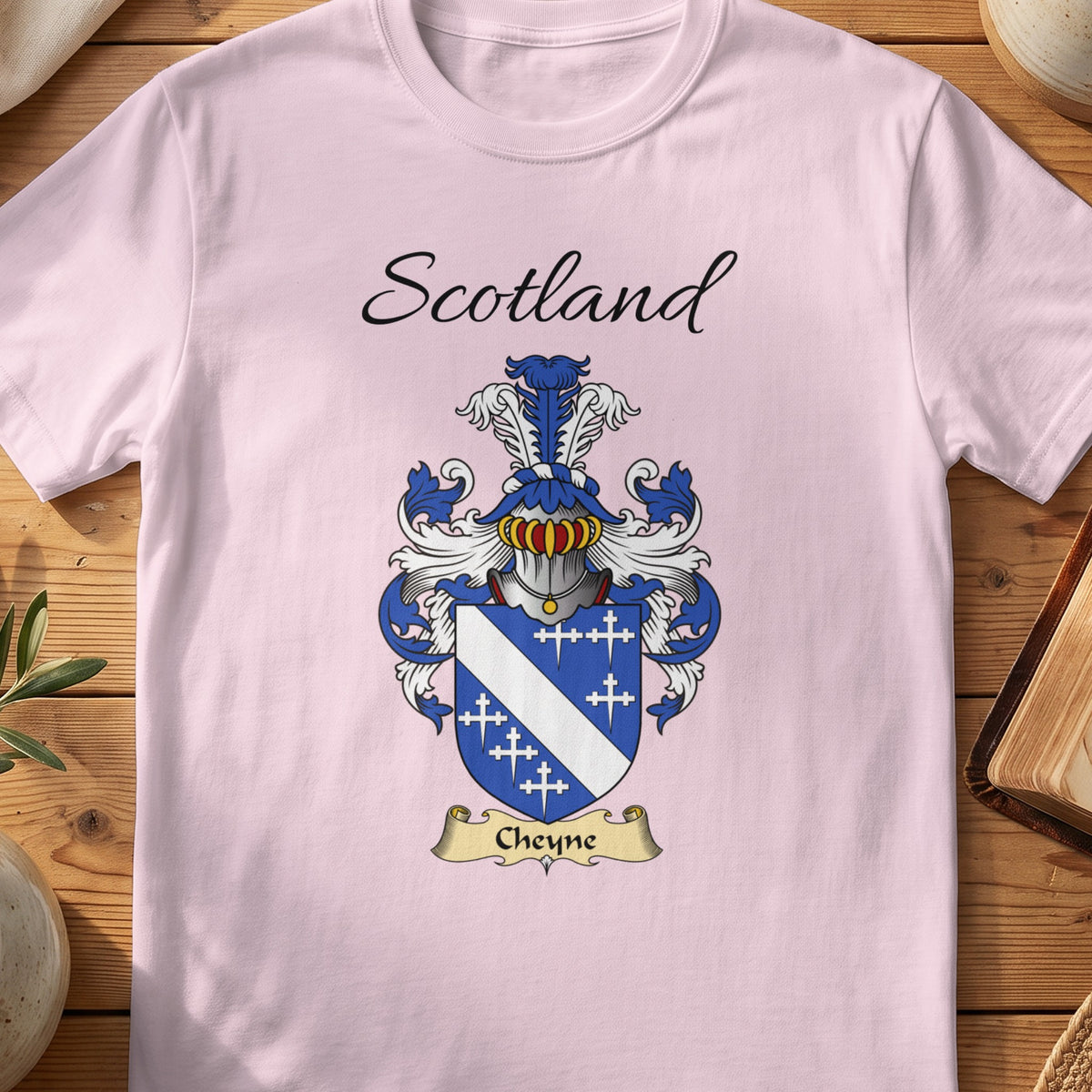 Light Pink Cheyne Scottish family shield T-shirt featuring a white diagonal band and small crosses on blue