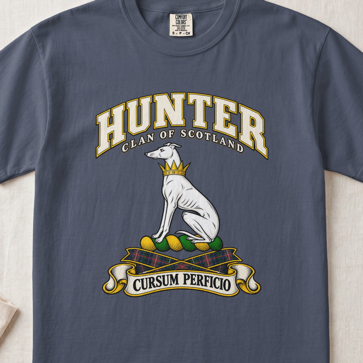 Hunter Scottish clan T-shirt in Midnight, front view with a seated white hound with a golden collar and motto banner.