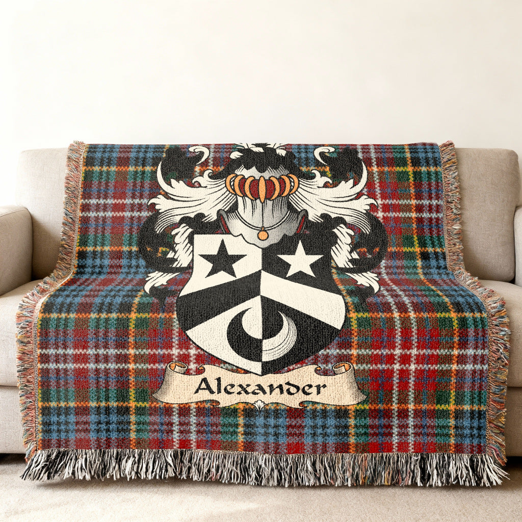 Alexander Scottish family shield woven blanket with Caledonia tartan background on a sofa