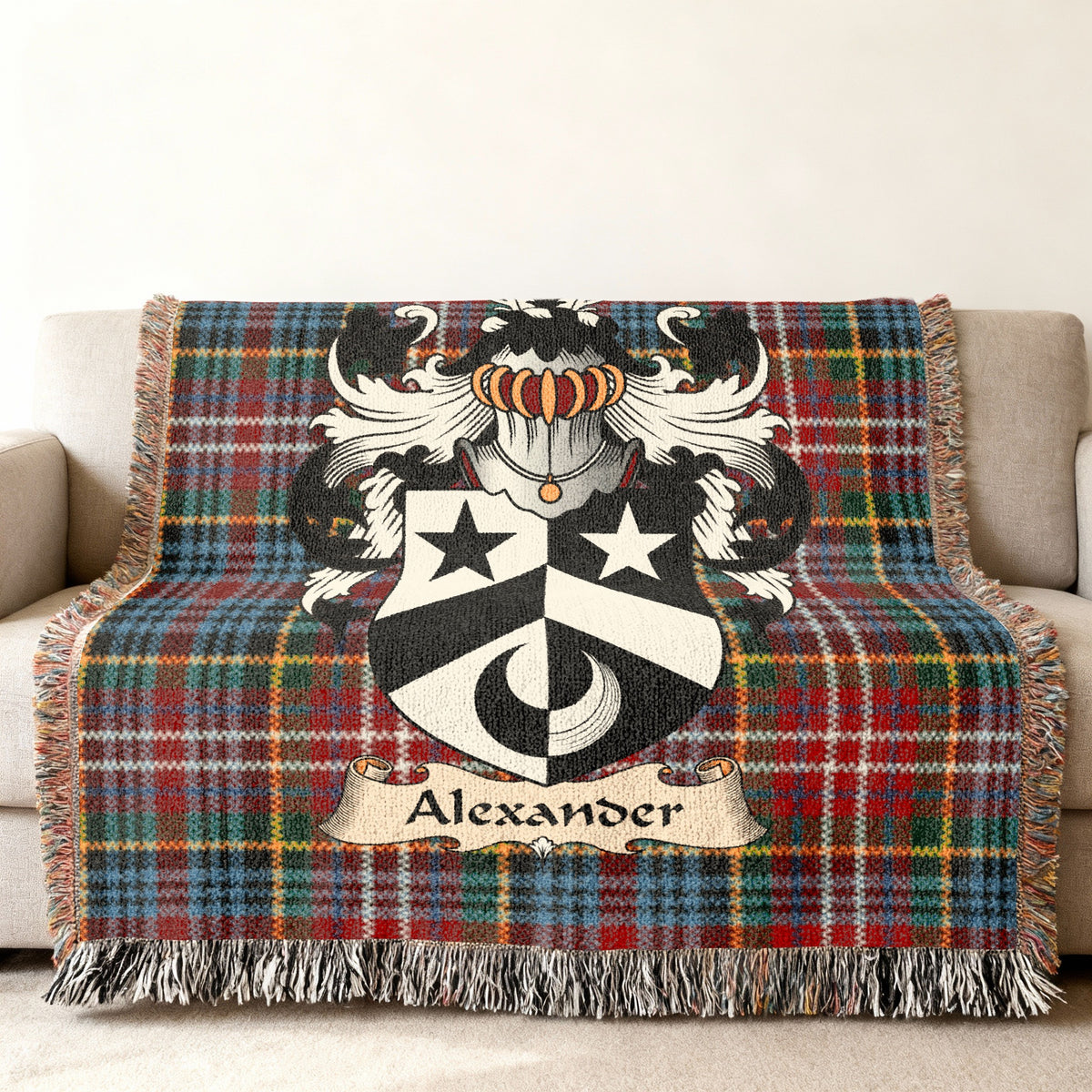 Alexander Scottish family shield woven blanket with Caledonia tartan background on a sofa
