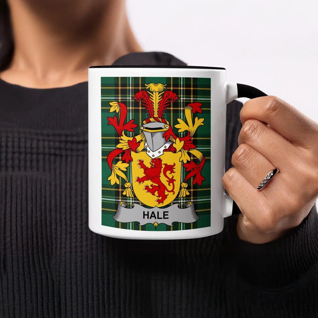 Hale family crest on a mug held by a person.