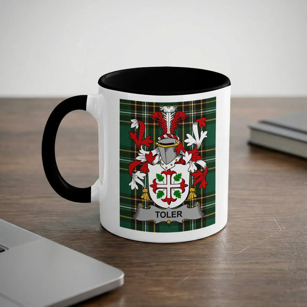 White mug with black handle featuring the TOLER family crest on a tartan background.