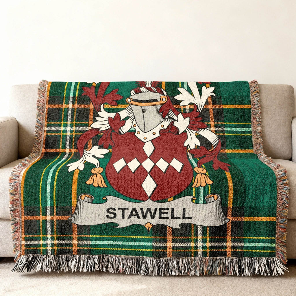 Green plaid throw blanket with a coat of arms and "STAWELL" text.