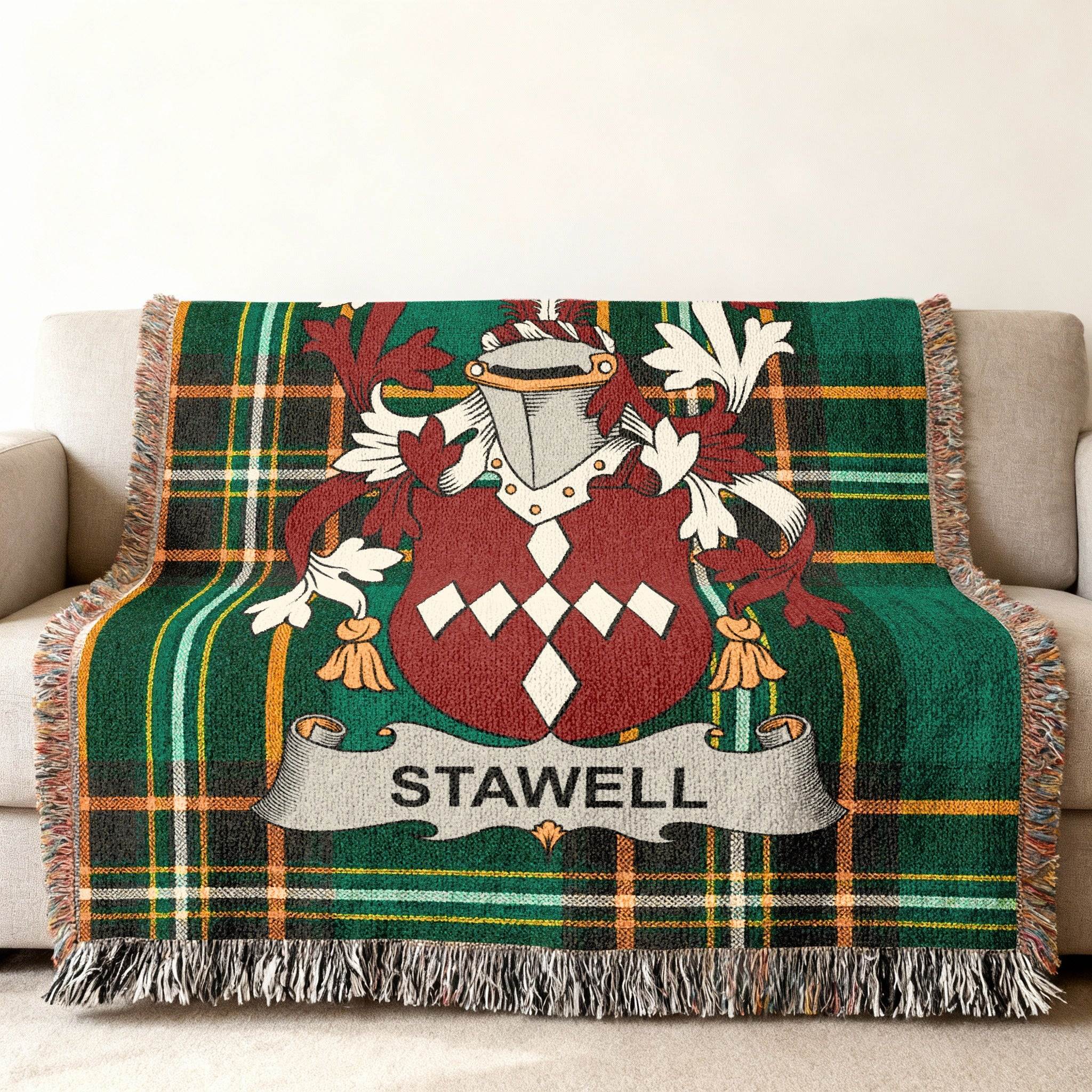 Green plaid throw blanket with a coat of arms and "STAWELL" text.