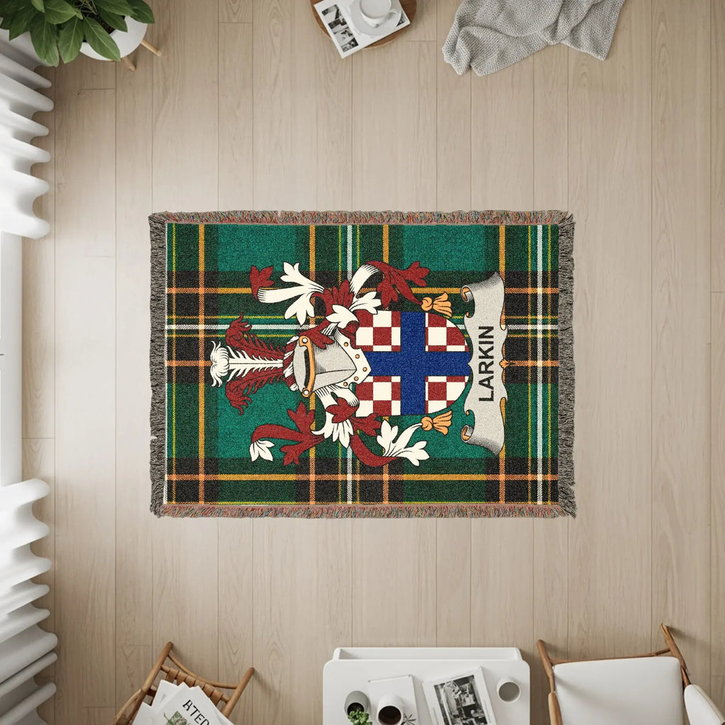 Larkin family crest on a green plaid woven blanket with fringe.