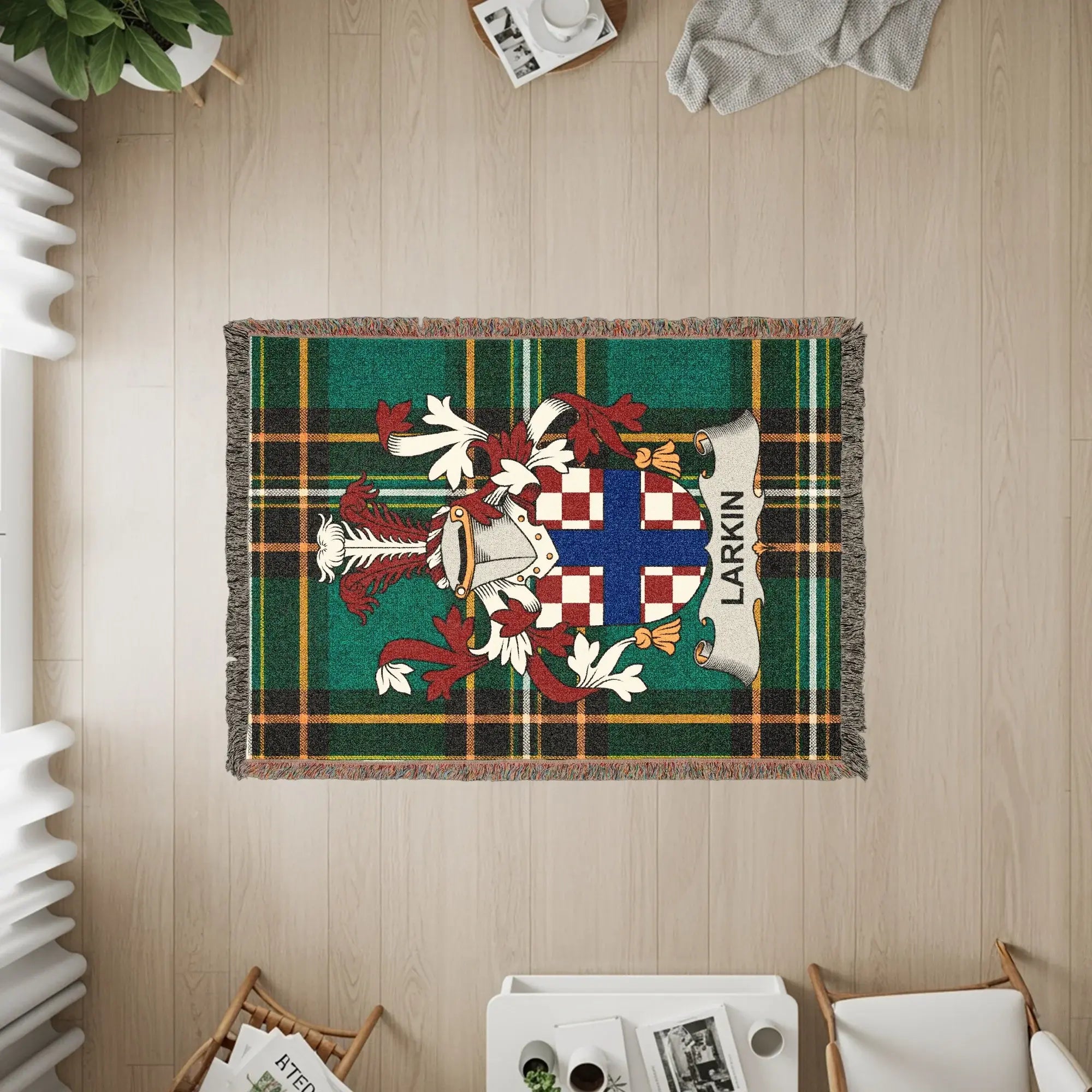Larkin family crest on a green plaid woven blanket with fringe.
