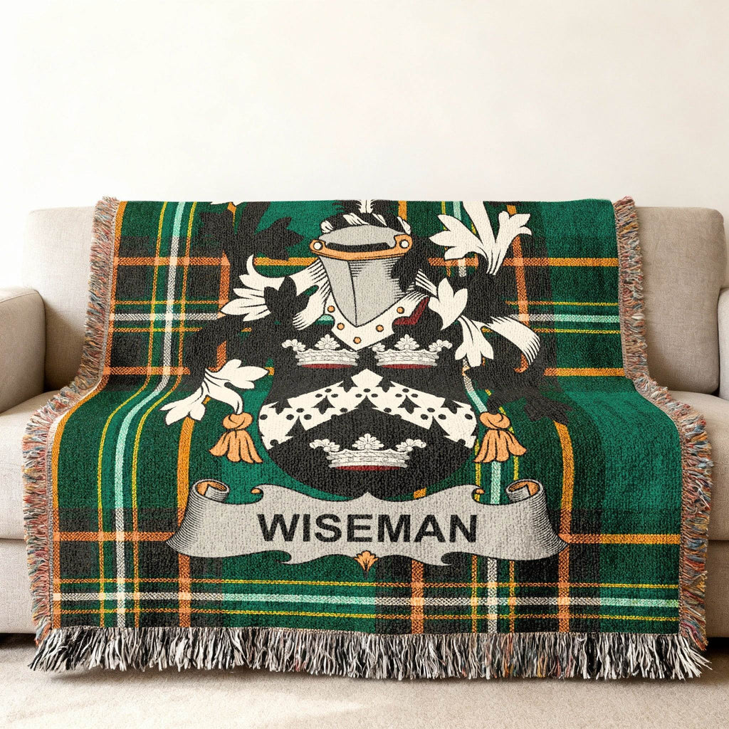 Woven blanket with Wiseman family crest and green tartan pattern.