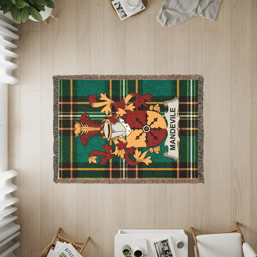 Green plaid throw blanket with Mandeville family crest and fringe.
