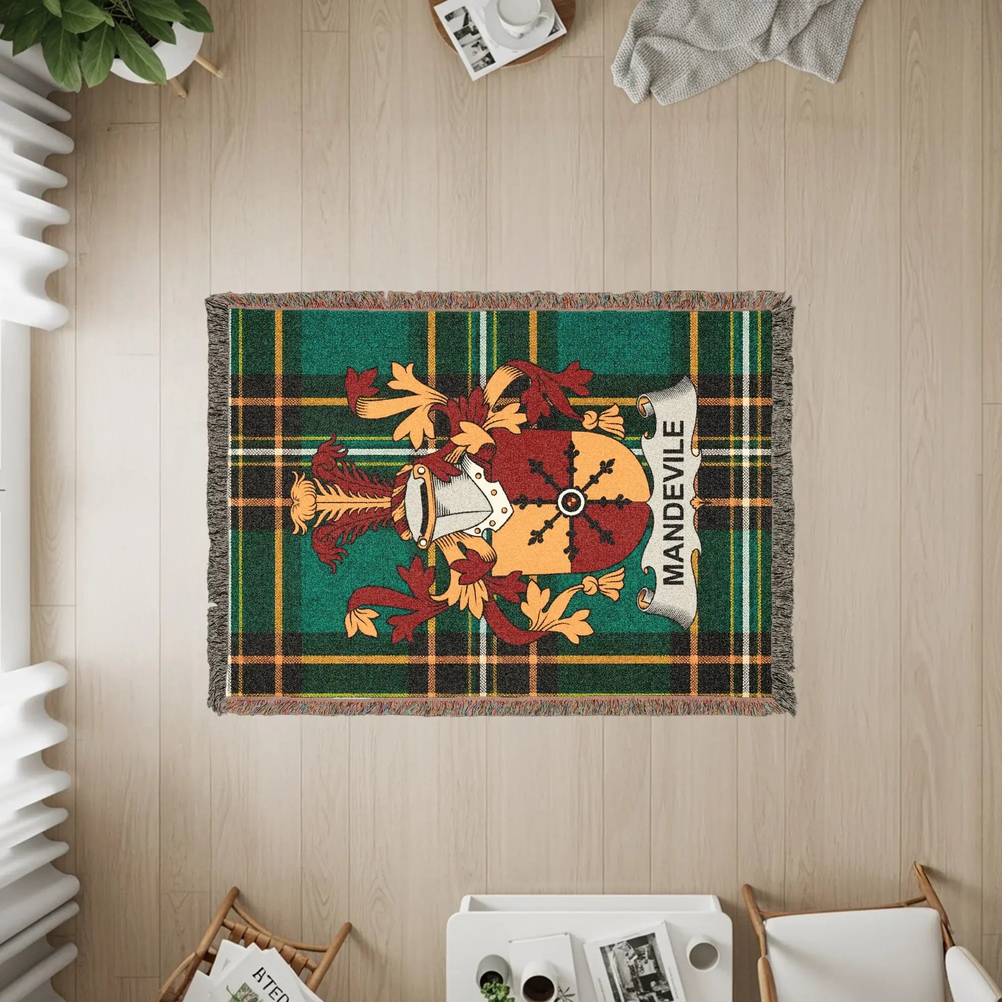 Green plaid throw blanket with Mandeville family crest and fringe.