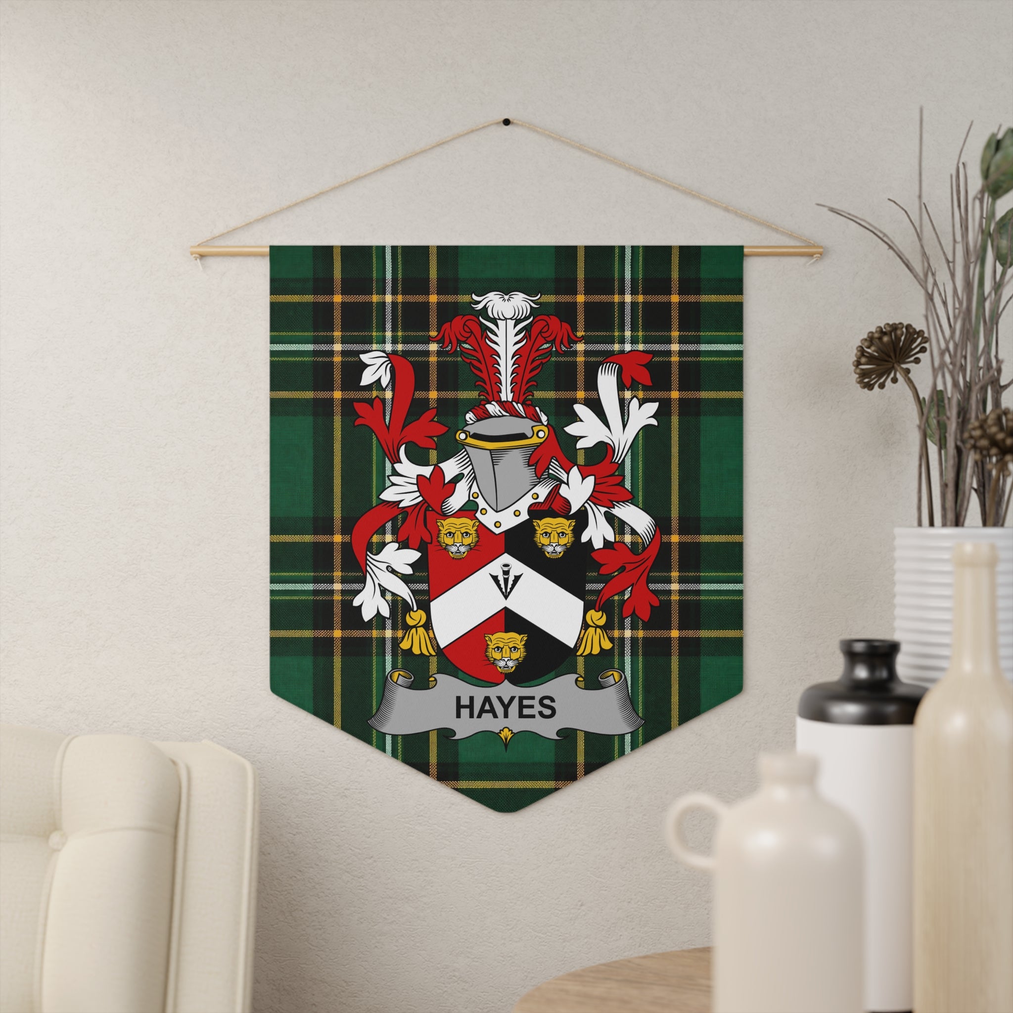 Hayes family crest on a green plaid banner hanging on a wall.