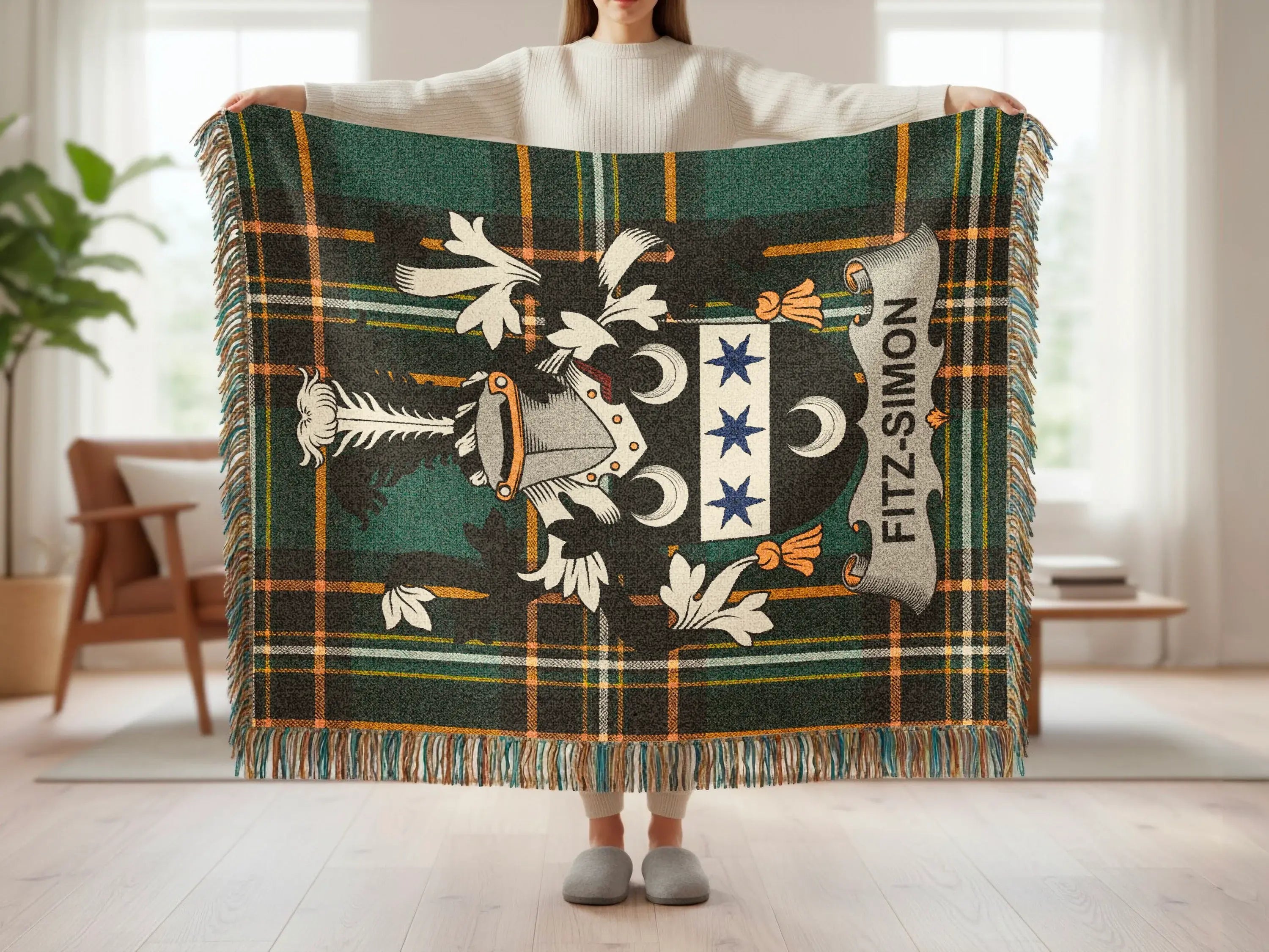 Tartan blanket with Fitz-Simon crest, held up by a person.