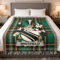 Tartan blanket with Whitfield family crest on a bed.
