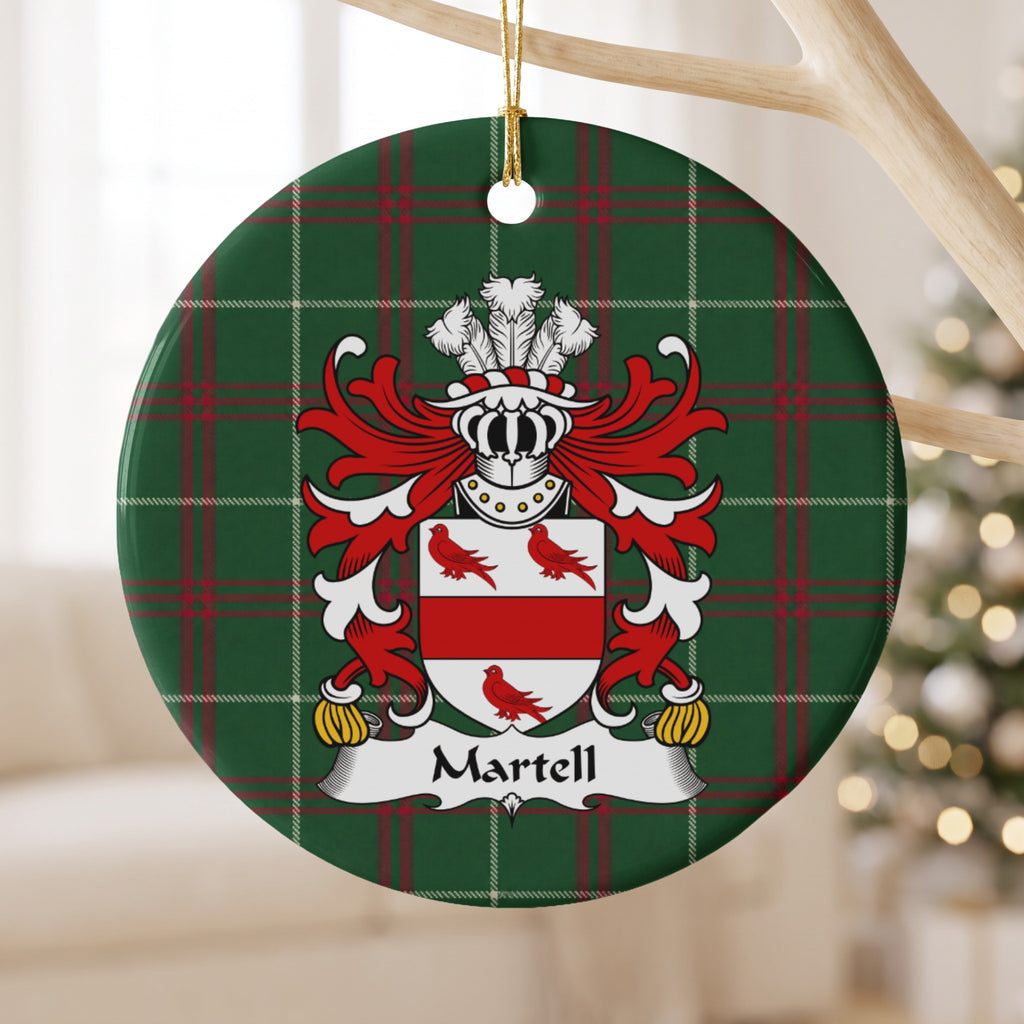 Martell ornament hanging from a pale wooden branch, showing a red horizontal band and three red birds on a white shield on Welsh National Tartan.