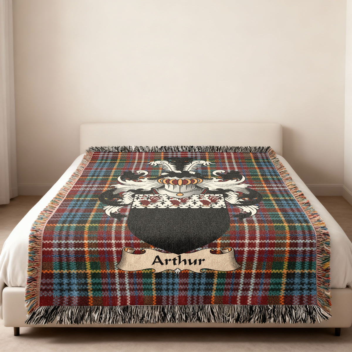 Arthur family crest emblem on a Caledonia tartan woven blanket